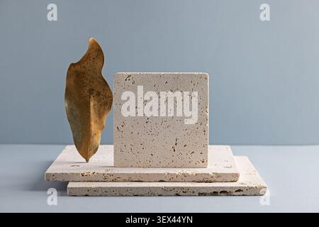 Minimalist Stone and Leaf Composition on Blue Background for Modern Design Stock Photo