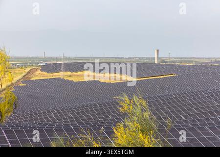 Expansive solar farm generating renewable electricity, with a large scale photovoltaic power plant for sustainable development Stock Photo