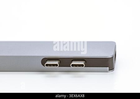 Detailed macro shot of two USB Type-C ports on the side of a modern silver aluminum laptop computer, showcasing precision engineering and connectivity Stock Photo