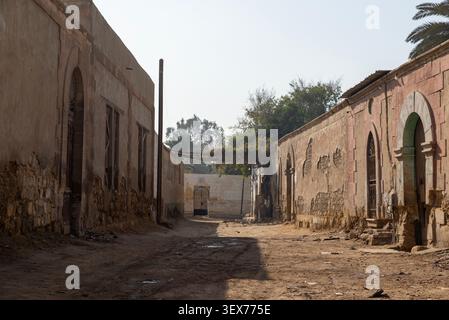 Narrow dirt alley between crumbling stone walls, City of the Dead, Cairo, Egypt Stock Photo