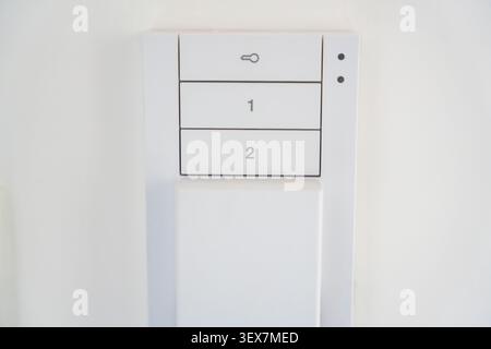 Close up of a home intercom control panel on a wall near an apartment entrance. Residential access control concept for security, communication and Stock Photo