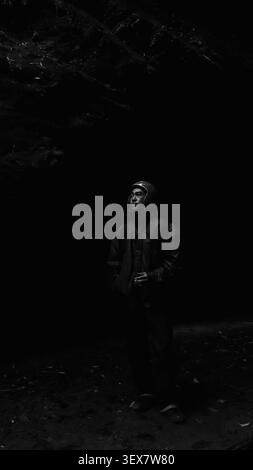 Dramatic Monochrome Portrait of Male Motorcyclist in Helmet on Ha Giang Road Trip Stock Photo