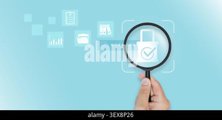Magnifying glass with digital padlock icon with business data icons. Concept of cybersecurity, data privacy protection, information auditing and secur Stock Photo