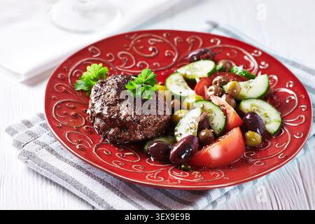 Fried hamburger steak with fresh salad Stock Photo