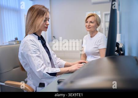 Caucasian women collaborating in a medical office during daytime Stock Photo
