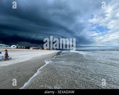 A storm rolling in with dark ominous storm clouds over the beach and ocean at Ponte Vedra beach in Florida. Stock Photo