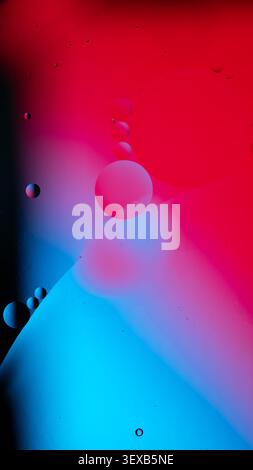 Oil bubbles floating on a water surface, forming a colorful abstract background Stock Photo