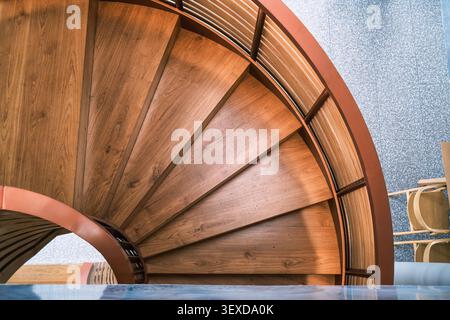 Elegant spiral wooden staircase steps and interior modern design on marble floor Stock Photo