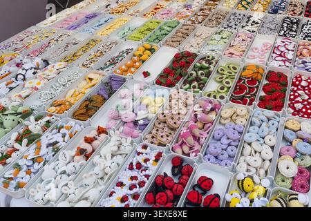Collection of small handmade buttons and craft accessories displayed at a street market stall Stock Photo