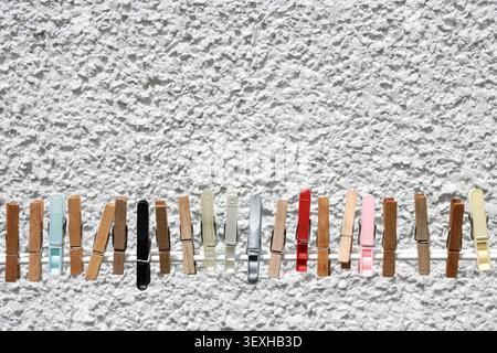 A line of old plastic and wooden laundry pegs Stock Photo
