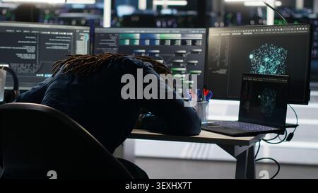 Frustrated data center worker reacts to malfunctioning node tree software and technical errors during AI analysis. Stock Photo