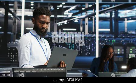 Data center engineer uses node tree software to identify equipment performance issues and data patterns. Stock Photo