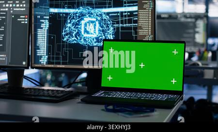 IT specialist reviews neural network visualization on green screen computers in a server room during software debugging work. Stock Photo