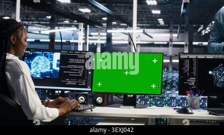 IT colleagues collaborate in a data center while reviewing AI diagnostics and infrastructure performance. Stock Photo
