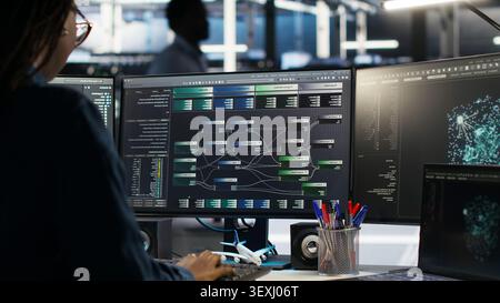 Engineer reacts with frustration in a server farm as node tree systems fail to categorize unstructured data. Stock Photo