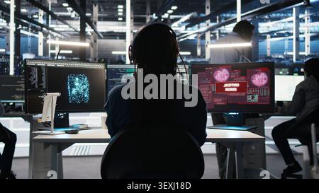 Data infrastructure center software programmer seeing urgent system alert message. Stock Photo