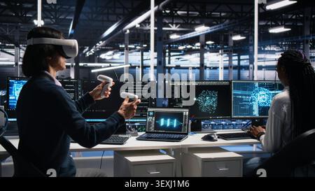 High tech server room technical specialist working with virtual reality. Stock Photo