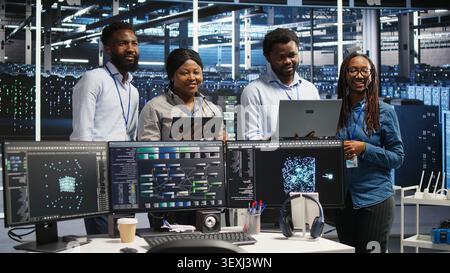 Engineers use a computer workstation in a server hub to categorize unstructured data with node tree systems. Stock Photo