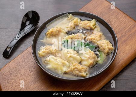 Chinese Three Fresh Wontons in Light Broth, Traditional Dumpling Soup Stock Photo