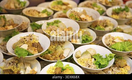 bowls of traditional mixed tofu served on a table, showcasing a delicious Asian-inspired dish with fresh ingredients and authentic presentation Stock Photo