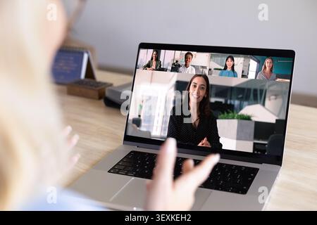 Diverse businesspeople displayed on laptop screen during video call meeting Stock Photo