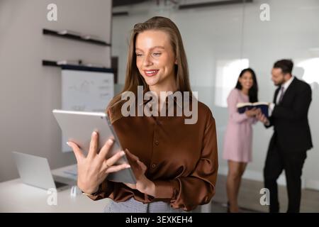 Caucasian businesswoman using digital tablet during office meeting Stock Photo