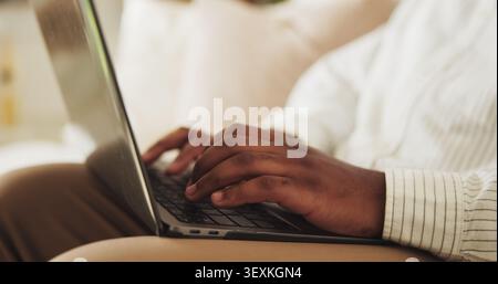 Hands, typing and man in house with laptop for remote work on online web development project. Keyboard, information and software engineer with Stock Photo