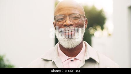 Smile, outdoor and portrait of black man in new house for assisted living center, pride and relax. Moving in, retirement home and glasses with elderly Stock Photo