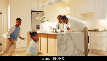 Laptop, discussion and parents with kids in kitchen for playing on weekend with online savings. Run, African people and children with mother and Stock Photo