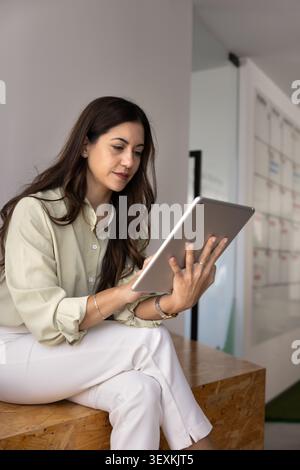 Businesswoman or office employee using digital tablet Stock Photo