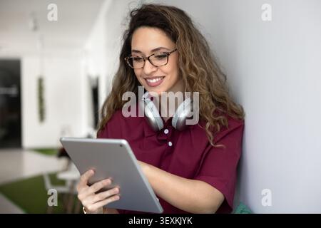 Woman working on digital tablet in coworking office Stock Photo