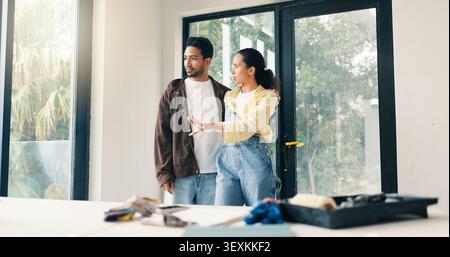 Talking, idea and couple in home for renovation, interior design and decoration for new house. Marriage, planning and man with woman with diy project Stock Photo