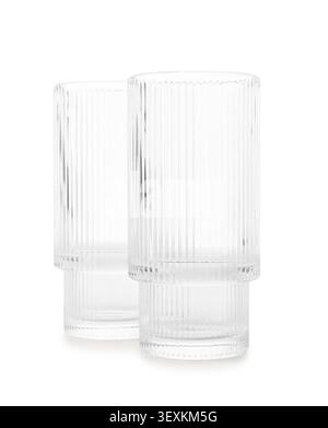 Two empty ribbed glass tumblers on white background Stock Photo