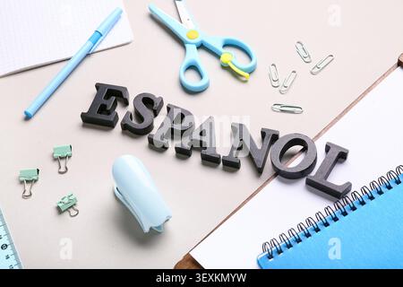 Office supplies with the word espanol on desk Stock Photo