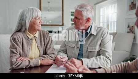 Financial advisor, paperwork and senior couple in home, smile and application for loan contract. Man, woman and consulting for pension fund Stock Photo