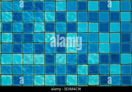 Blue and turquoise square tiles creating an underwater mosaic pattern with rippling water Stock Photo