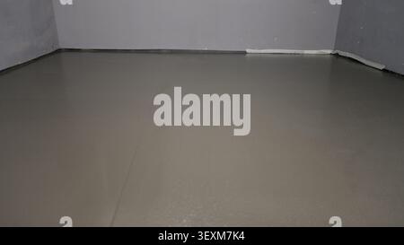 Wet self-leveling floor screed layer in room Stock Photo