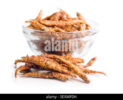 Crispy golden fried smelts. small fish piled on a white background, highlighting crunchy texture and savory appeal for seafood snacks, appetizers, cul Stock Photo