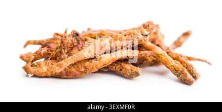 Crispy golden fried smelts. small fish piled on a white background, highlighting crunchy texture and savory appeal for seafood snacks, appetizers, cul Stock Photo