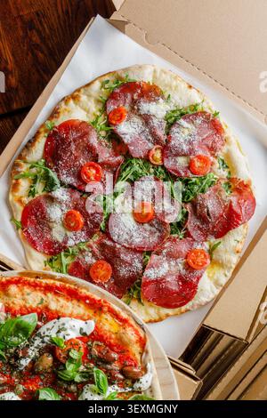 Craft pizza on delivery boxes, isolated. Professional studio lighting. Space for text. Stock Photo