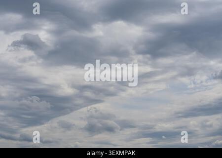 Gray storm clouds covering the sky before rain, forming a dramatic atmospheric background for weather themes. Stock Photo