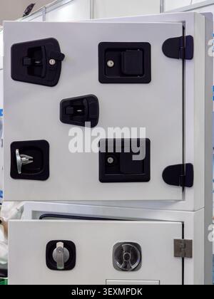 A professional display of high-quality industrial locking mechanisms and durable black handles designed for security in utility vehicles and commercia Stock Photo