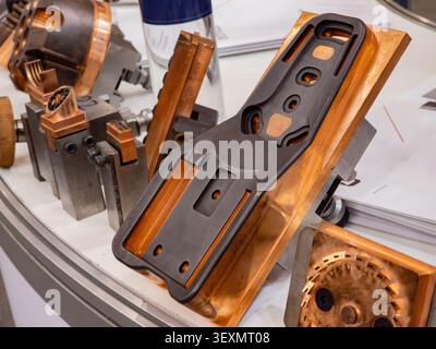 A close-up showcase of high-precision copper electrodes and industrial tooling components used in Electrical Discharge Machining (EDM) and mold manufa Stock Photo