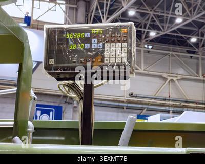 Close-up of a digital readout (DRO) control panel displaying coordinate measurements on an industrial metalworking machine in a factory workshop. Stock Photo