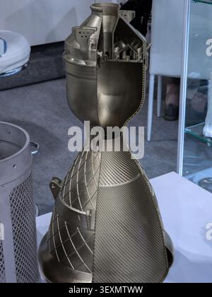 A highly detailed cutaway model of a 3D-printed metal rocket engine thrust chamber and nozzle, showcasing complex internal cooling channels and additi Stock Photo