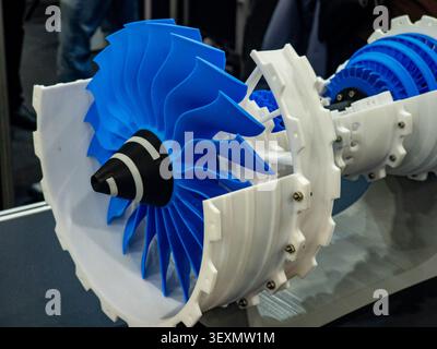 A detailed close-up of a 3D-printed model of a jet engine turbine, showcasing blue plastic blades and white casing, used for educational and aerospace Stock Photo