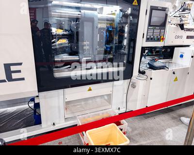 Ukraine, Kyiv - May 27, 2026:A high-tech automated plastic injection molding machine with a CNC control panel on display at an industrial trade show, Stock Photo