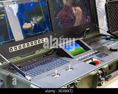 A professional military-grade portable ground control station for UAVs and drones, featuring dual monitors displaying geographic maps, flight telemetr Stock Photo