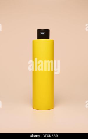 Yellow beauty bottle on beige background Stock Photo