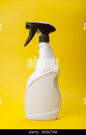 White Trigger Spray Bottle on Yellow Stock Photo